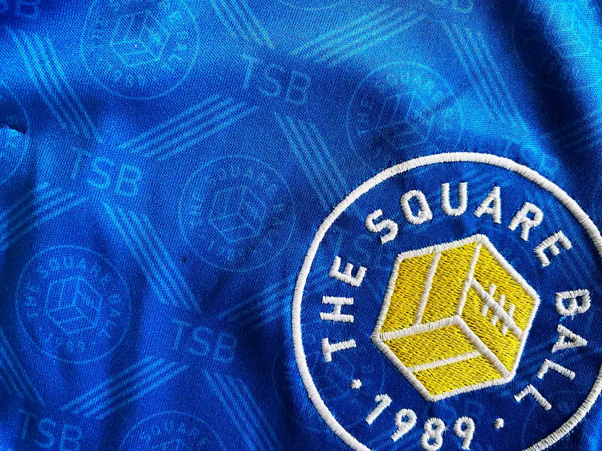 A badge sewn and sublimated onto a sports shirt.