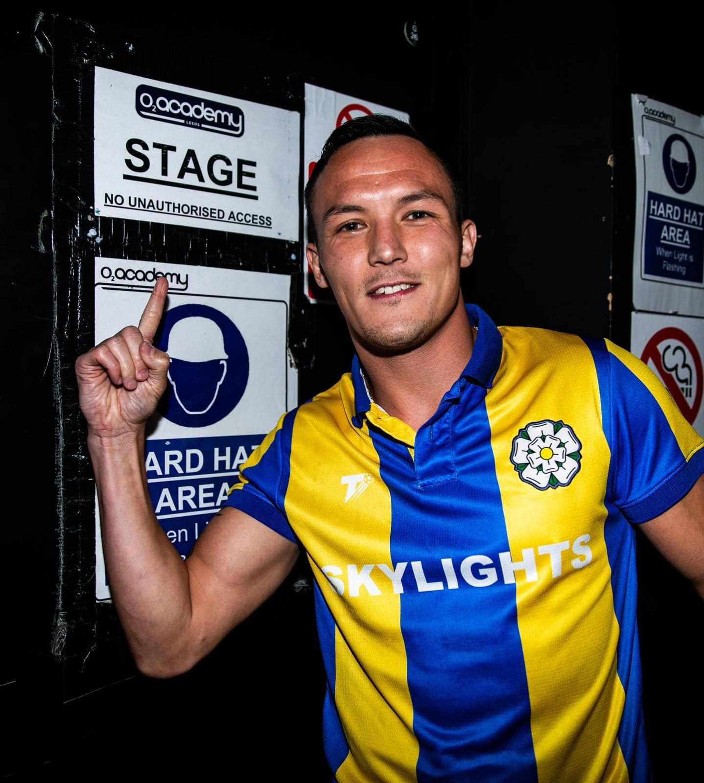 Boxer Josh Warrington wearing a shirt made by The Terrace for the band Skylights, inspired by a past Leeds United shirt.