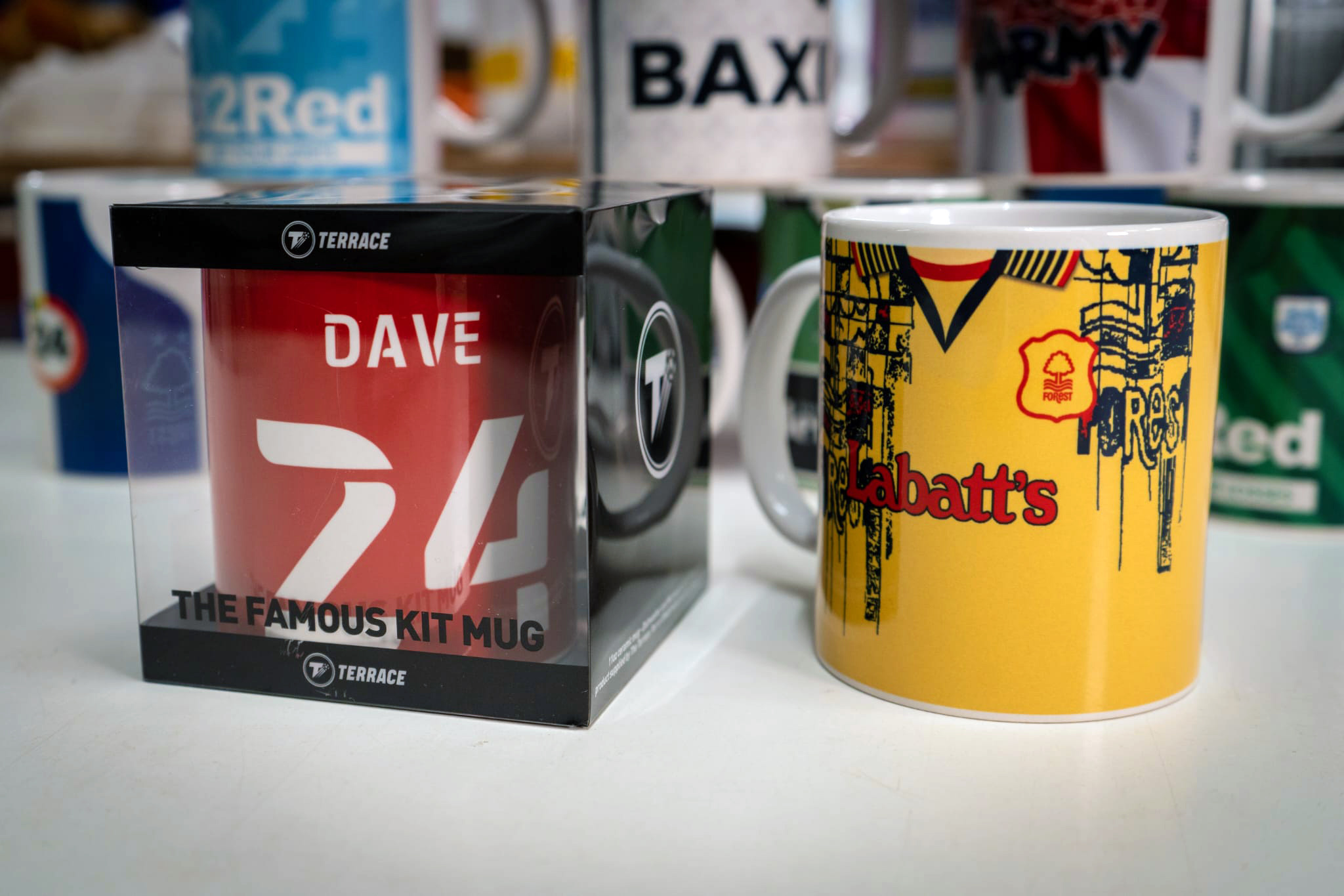 Two Nottingham Forest kit mugs, one still inside its packaging branded with The Terrace logo.