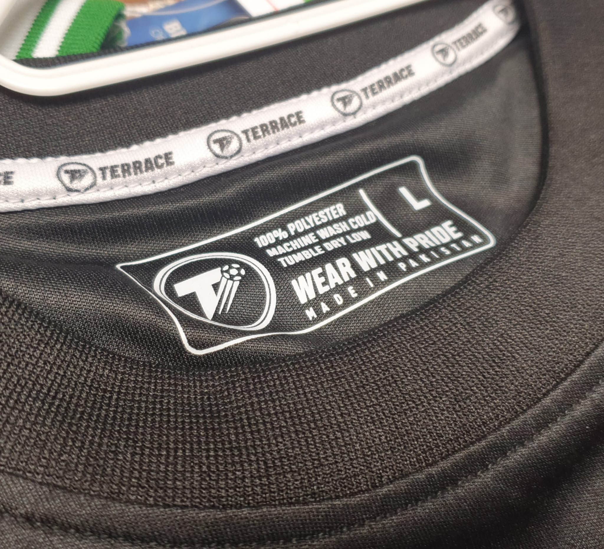 A close-up shows The Terrace logo printed inside a T-shirt collar.